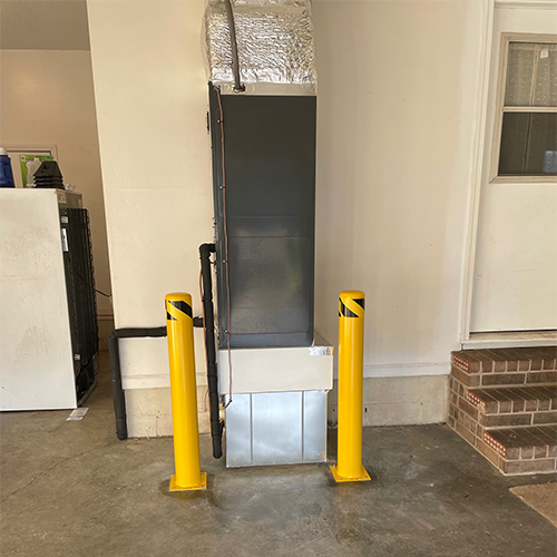 Indoor unit in garage with safety barrier for vehicles